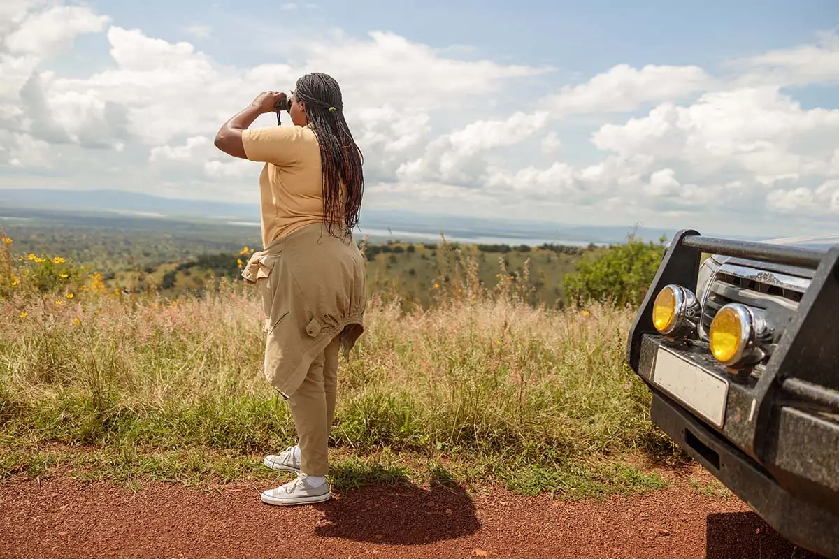 Female guide watching wildlife in Maasai Mara